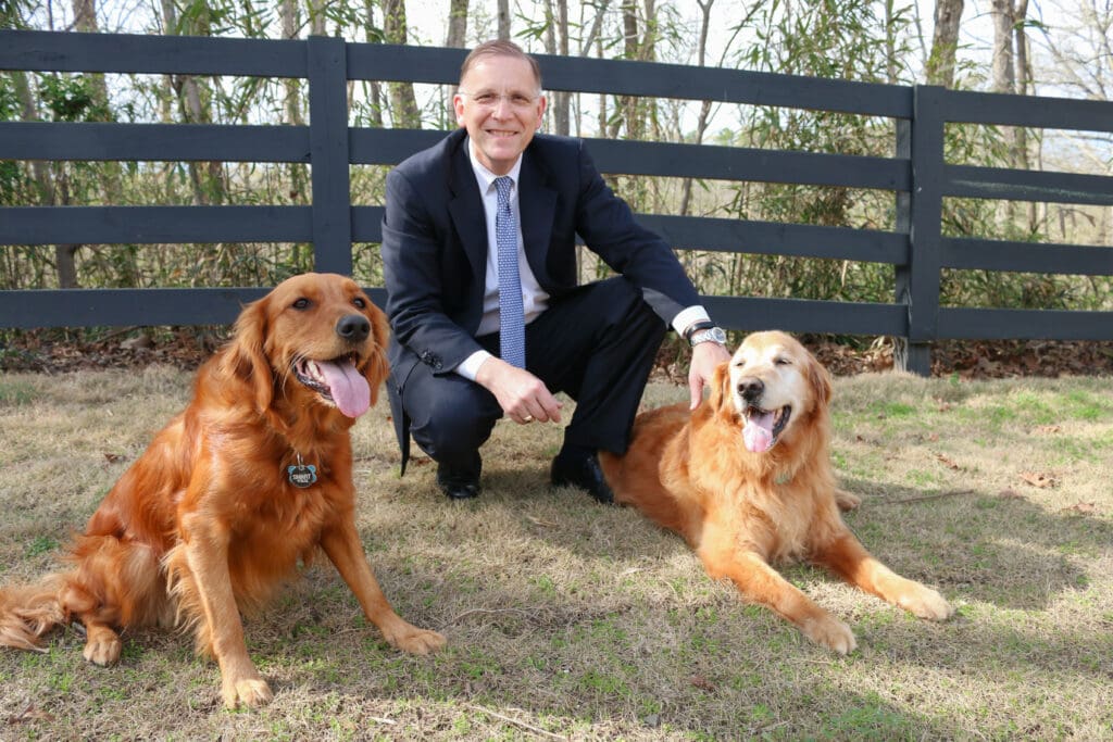 2 golden retrievers with Arkansas lawyer, Taylor King