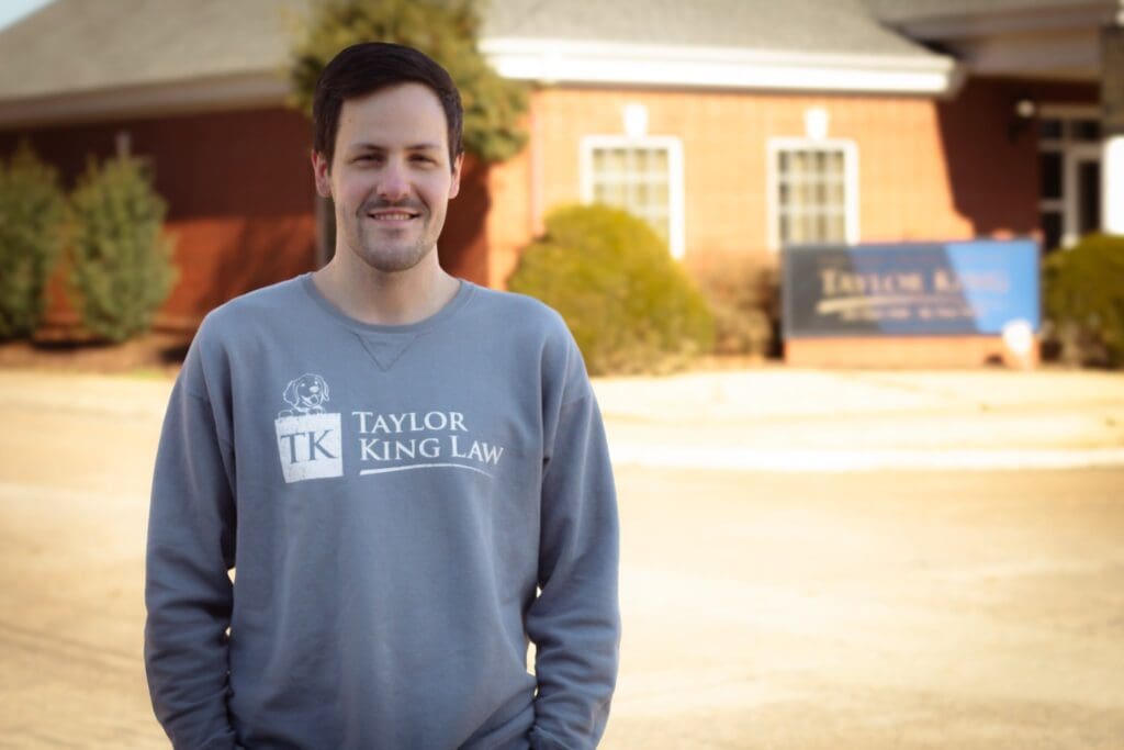 staff member in front of Arkadelphia law firm